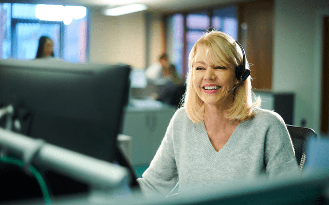 smiling woman working in call centre