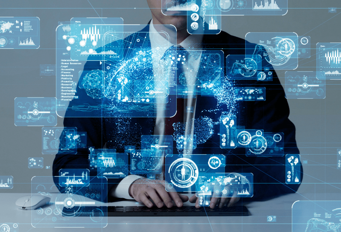 A professional in a suit typing on a laptop utilising virtualisation resources such as data analytics, network structures, and cloud services, embodying the concept of scalable and sustainable IT management.