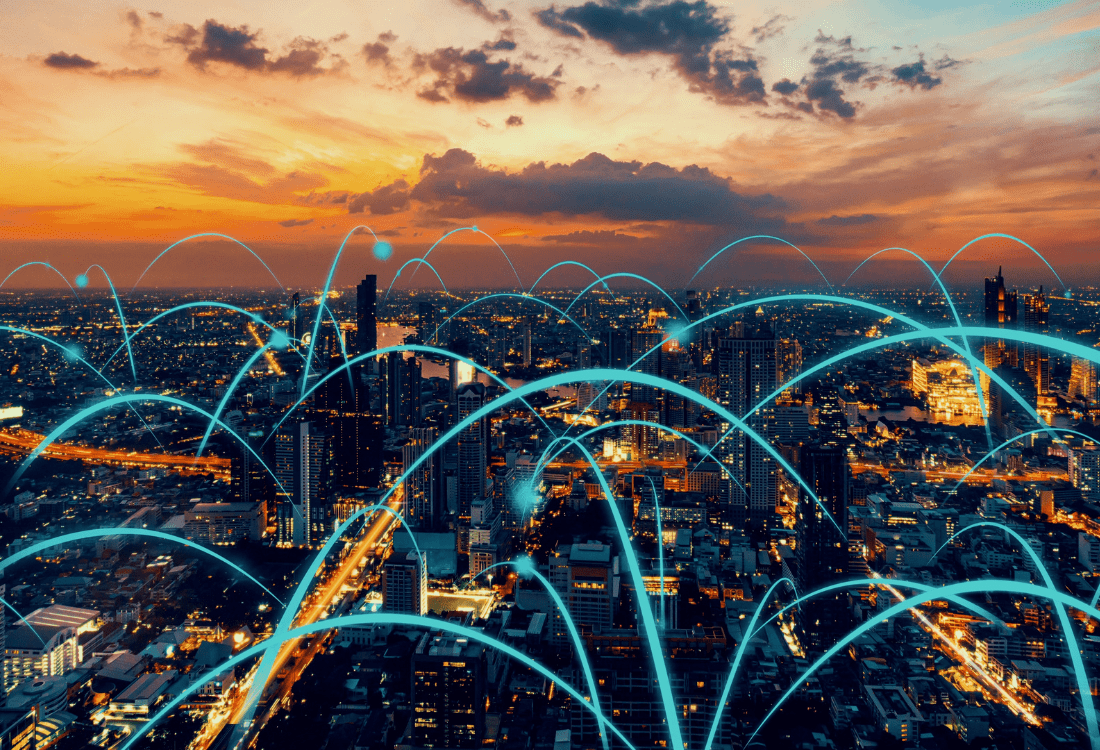 Aerial view of a city at dusk, with orange and cloudy skies, overlaid with glowing blue lines forming a network, which represents the move businesses make from HPE Nimble Storage to HPE Alletra.